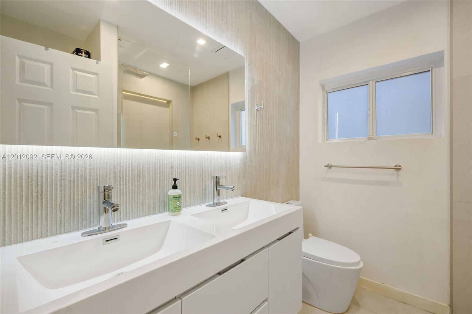 830 Northeast 72nd Street Miami, FL 33138 - Photo 12 of 19 a bathroom with a sink a toilet and shower