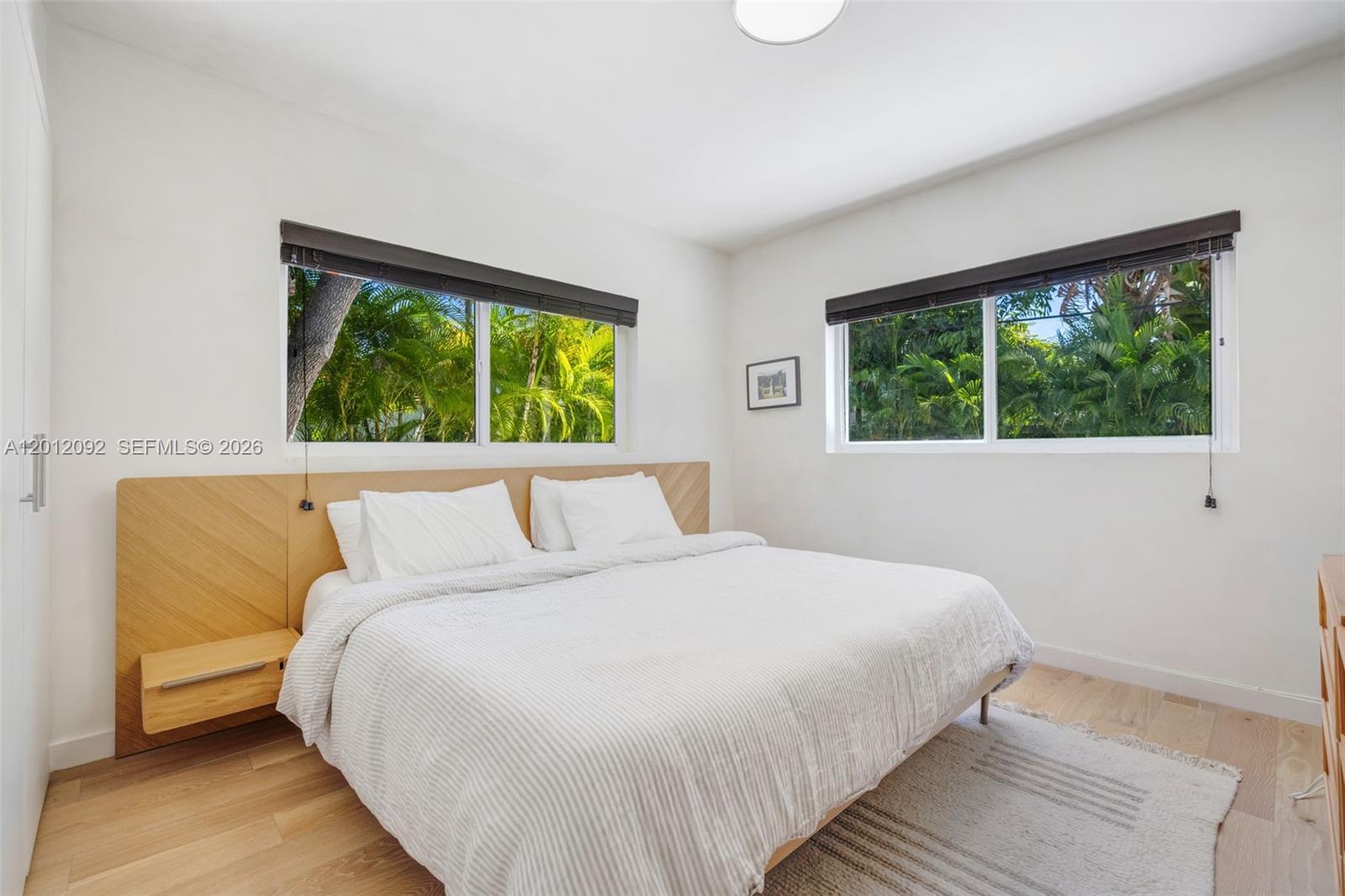 830 Northeast 72nd Street Miami, FL 33138 - Photo 13 of 19 a bedroom with a bed and a large window