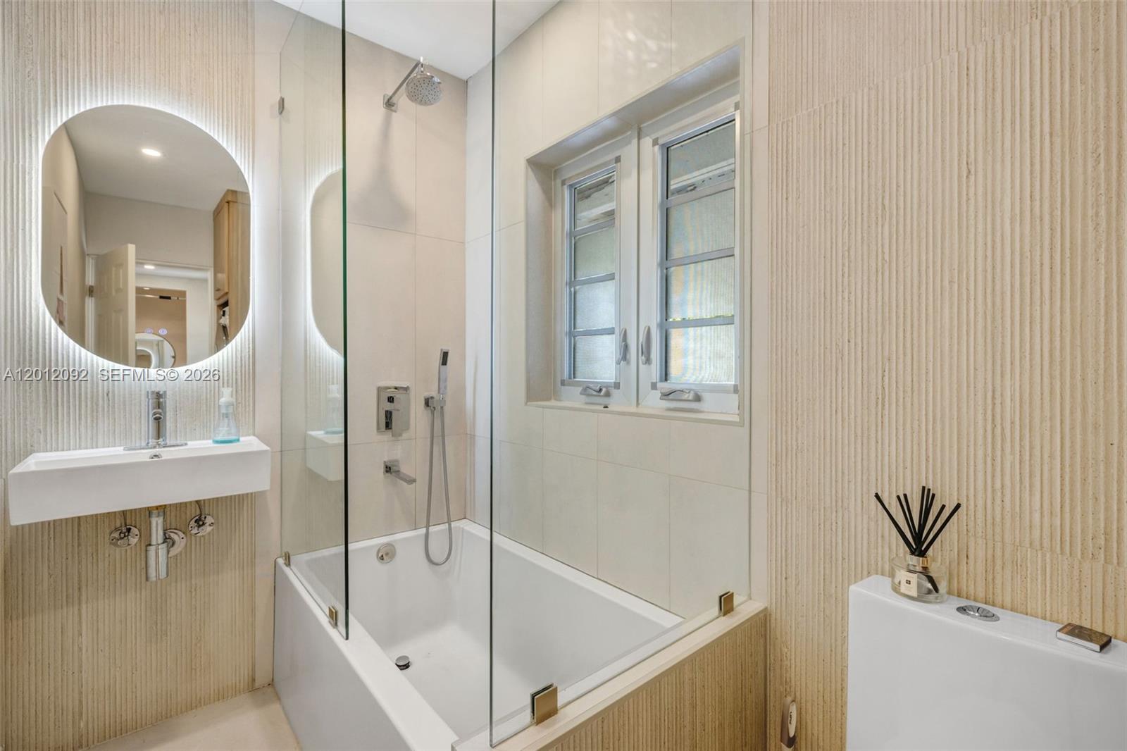 830 Northeast 72nd Street Miami, FL 33138 - Photo 14 of 19 a bathroom with a tub a sink and mirror