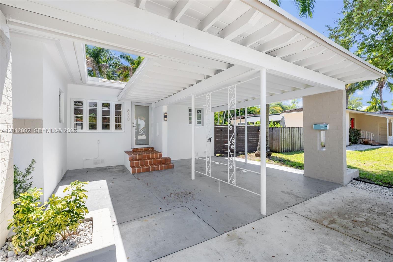 830 Northeast 72nd Street Miami, FL 33138 - Photo 2 of 19 a view of a patio with couches table and chairs and potted plants