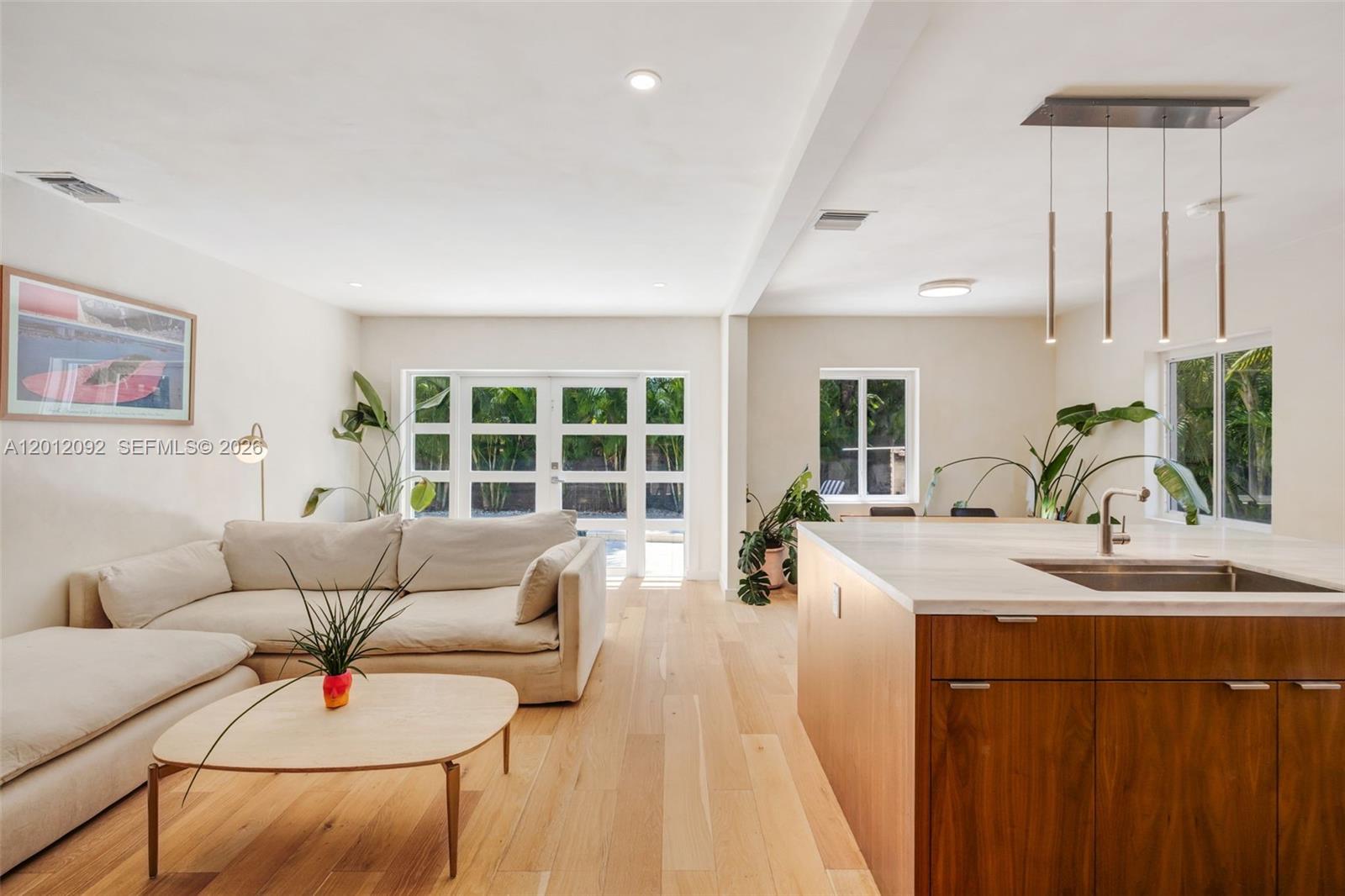830 Northeast 72nd Street Miami, FL 33138 - Photo 3 of 19 a living room with furniture and a large window