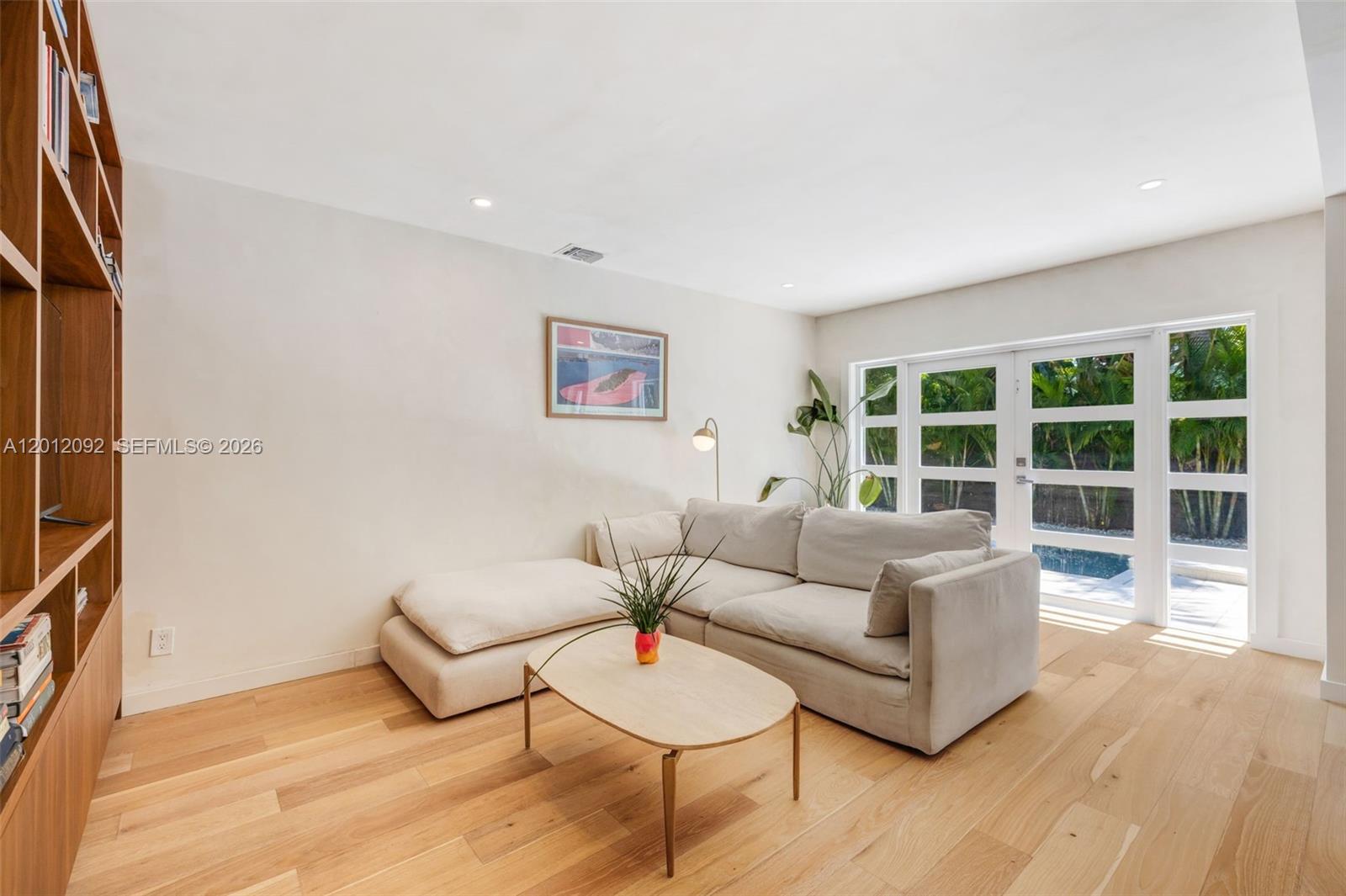 830 Northeast 72nd Street Miami, FL 33138 - Photo 4 of 19 a living room with furniture and a large window