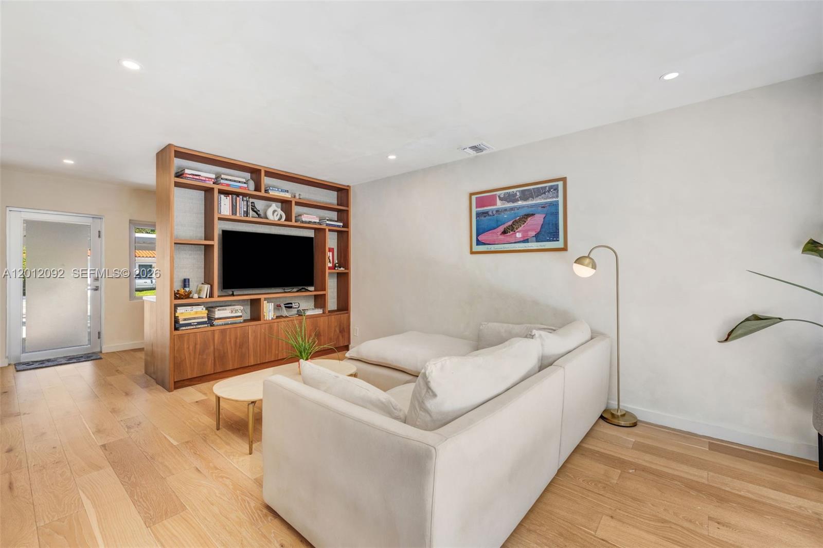 830 Northeast 72nd Street Miami, FL 33138 - Photo 5 of 19 a living room with furniture and a flat screen tv