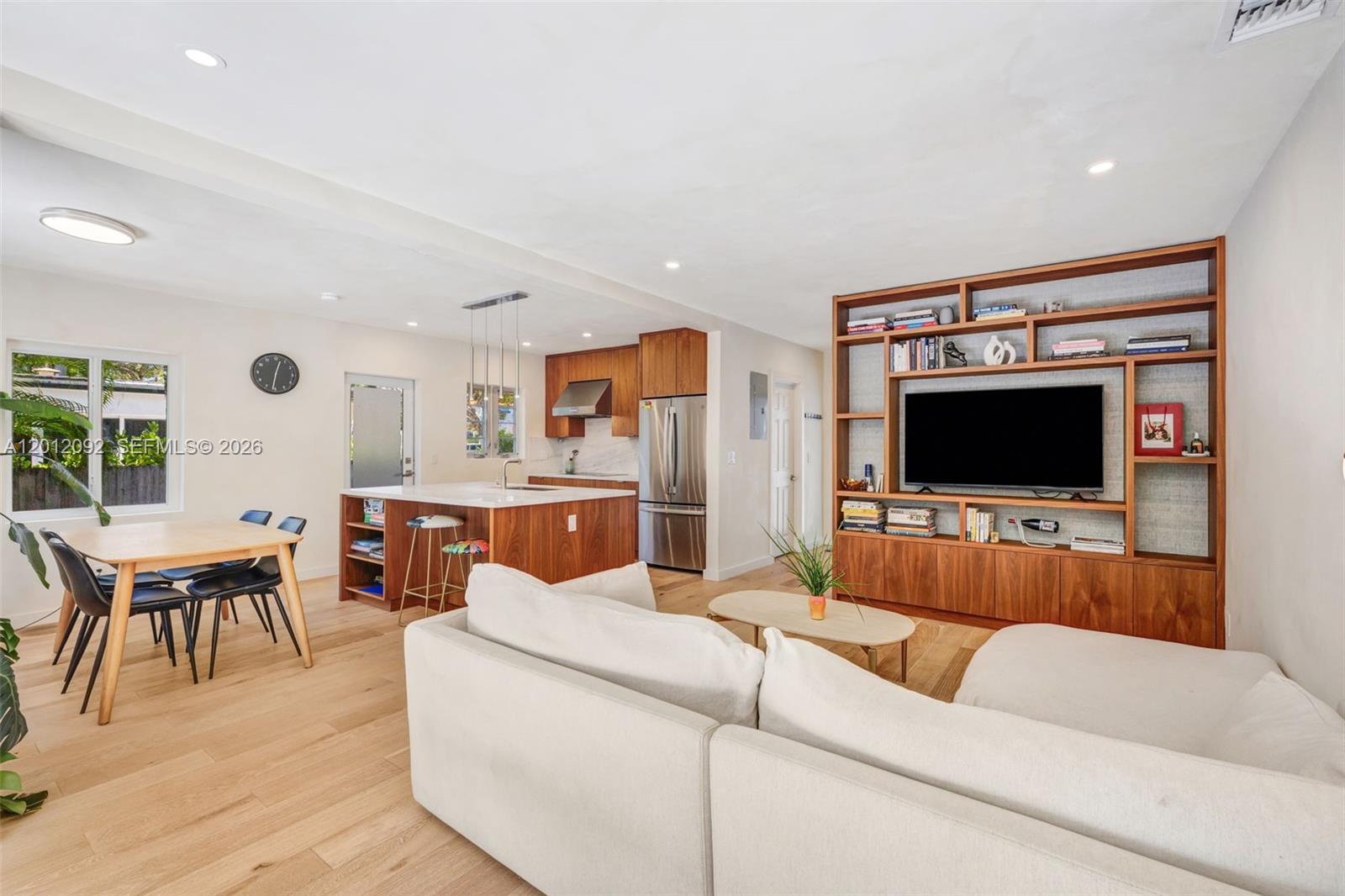 830 Northeast 72nd Street Miami, FL 33138 - Photo 6 of 19 a living room with furniture and a flat screen tv