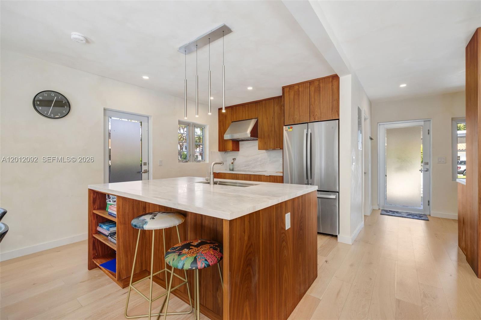 830 Northeast 72nd Street Miami, FL 33138 - Photo 7 of 19 a kitchen with stainless steel appliances a sink and a refrigerator