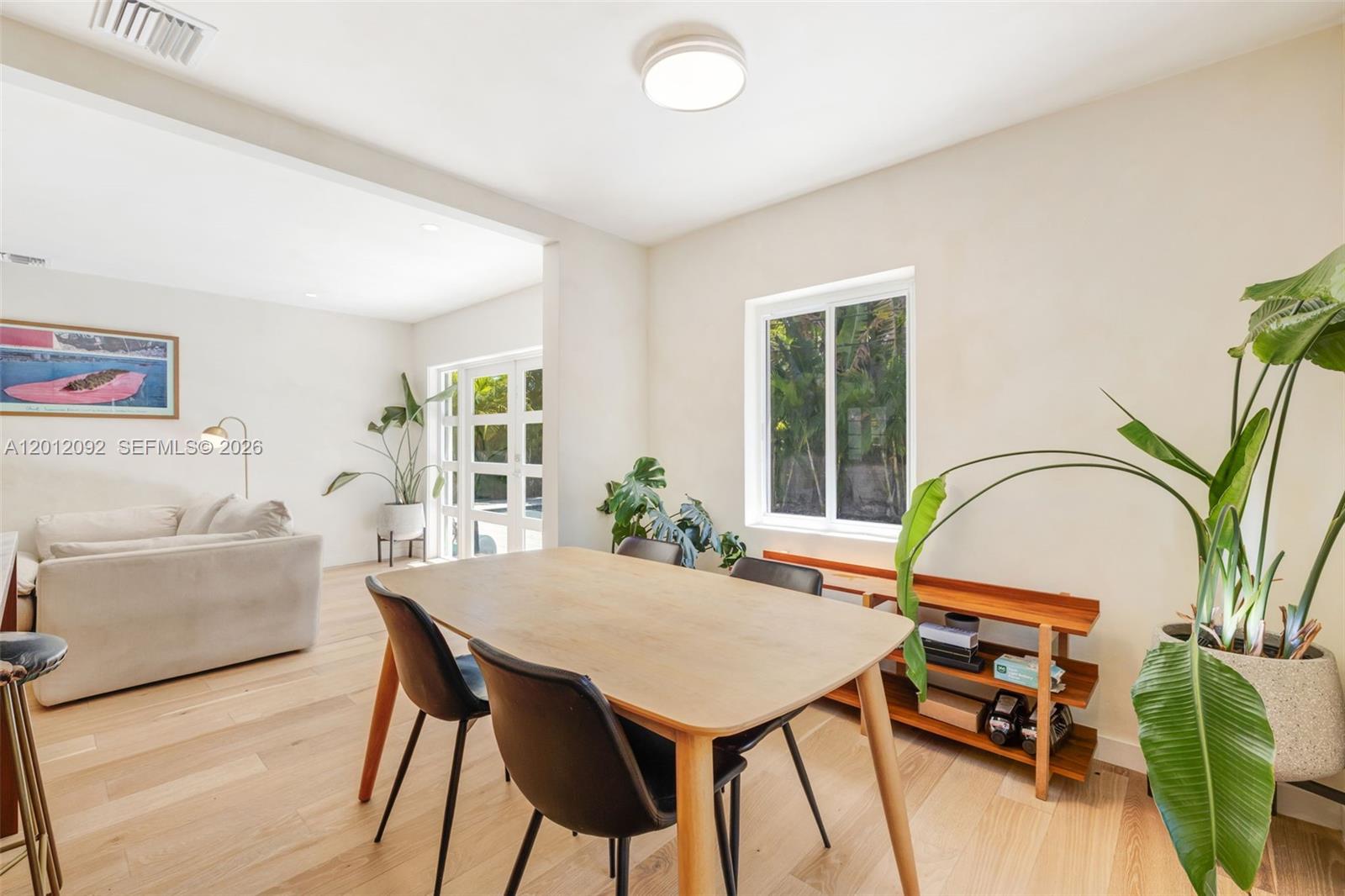 830 Northeast 72nd Street Miami, FL 33138 - Photo 9 of 19 a view of a dining room with furniture window and wooden floor