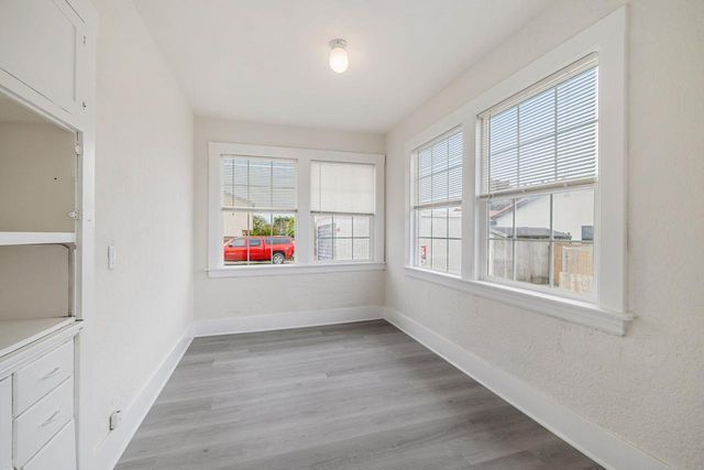 a view of a room with wooden floor and windows