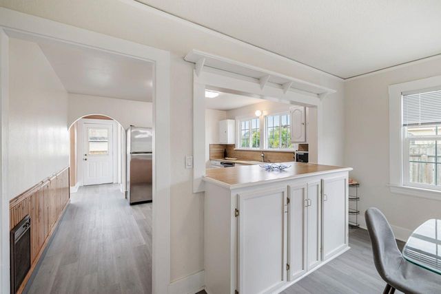 a bedroom with a bed and a flat tv screen on the dresser