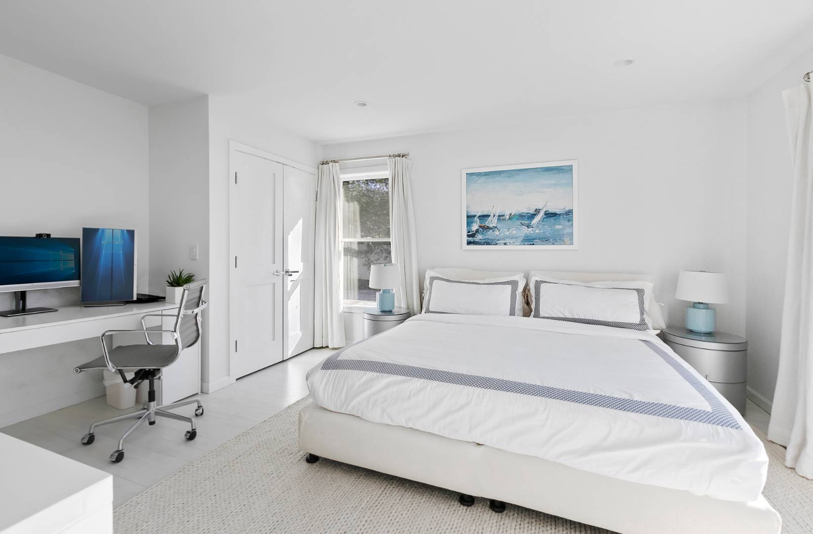 47 Tansey Lane Bridgehampton, NY 11932 - Photo 12 of 28 a spacious bedroom with a bed a table and a workspace