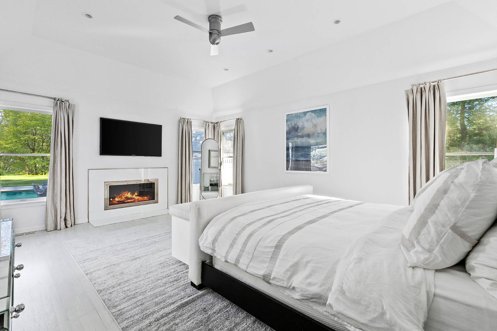 47 Tansey Lane Bridgehampton, NY 11932 - Photo 14 of 28 a spacious bedroom with a large bed and a fireplace