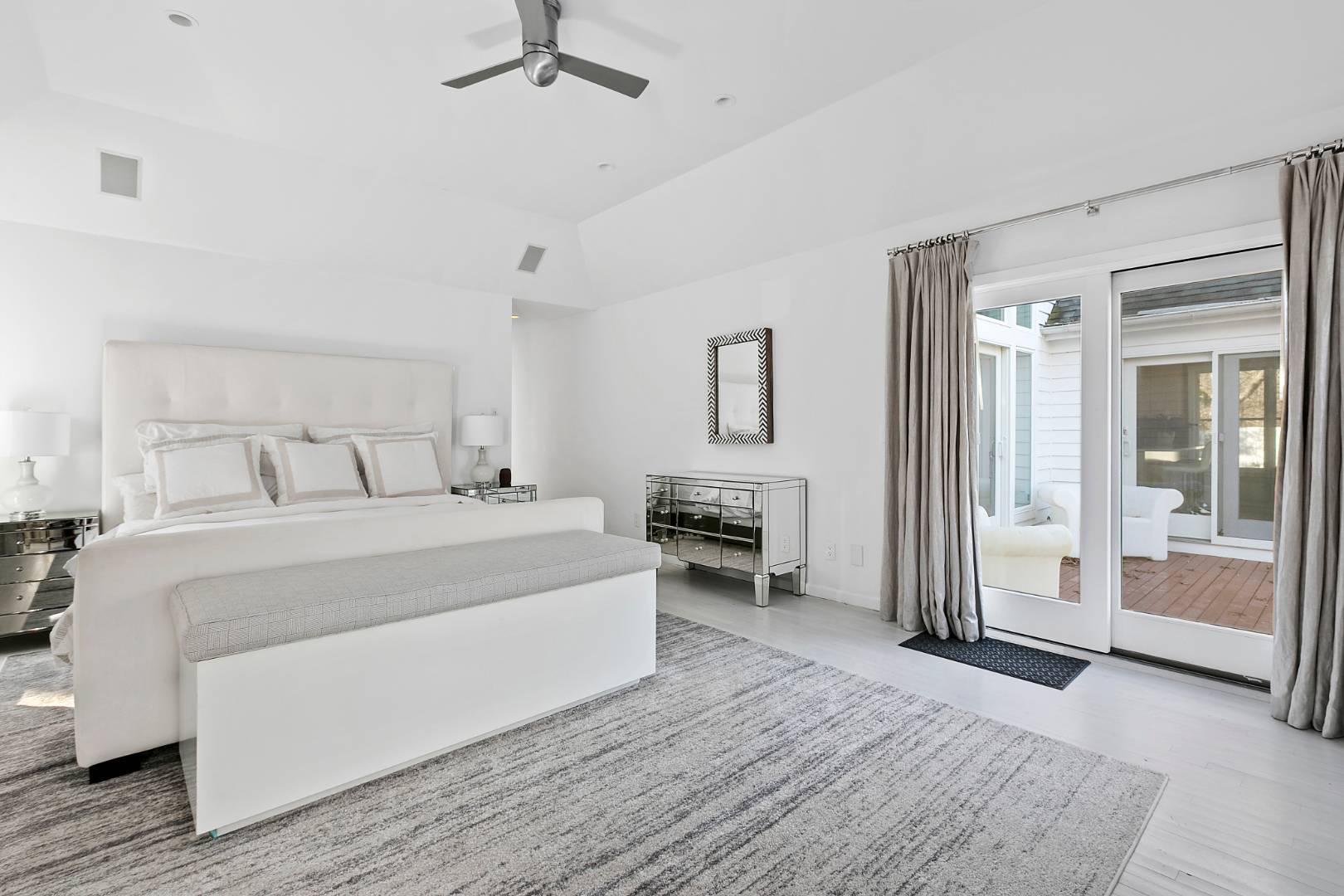 47 Tansey Lane Bridgehampton, NY 11932 - Photo 15 of 28 a spacious bedroom with a bed and a view of bathroom