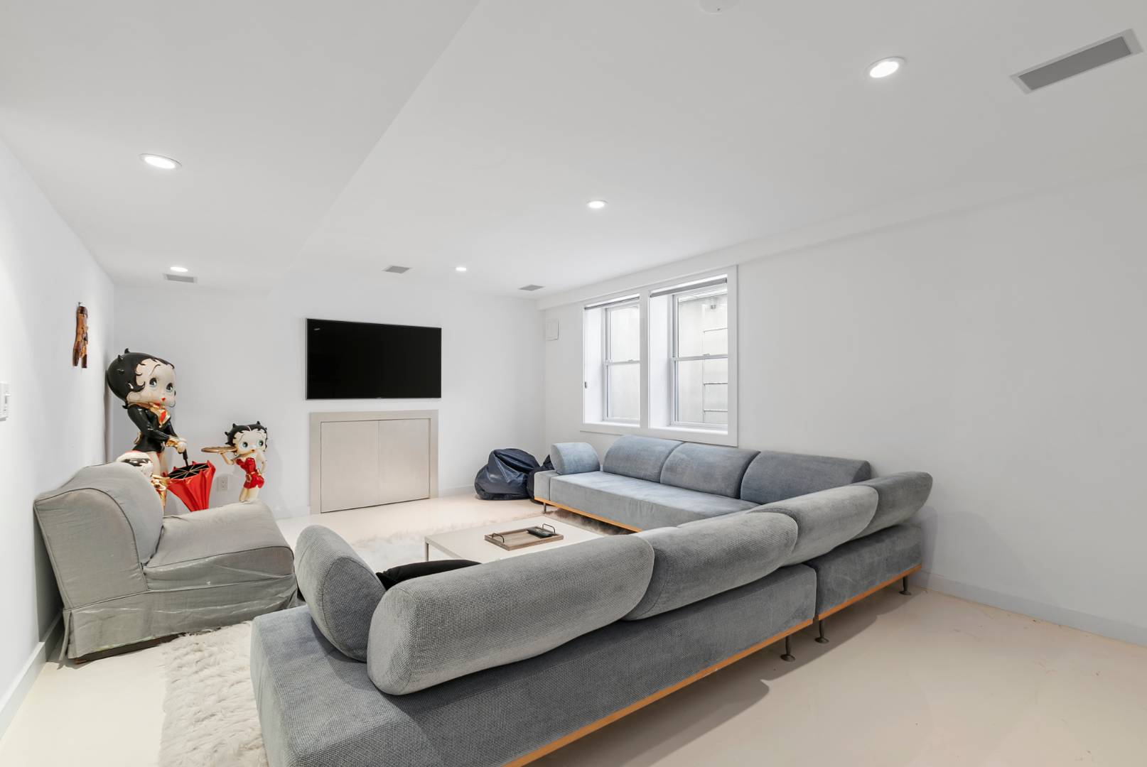 47 Tansey Lane Bridgehampton, NY 11932 - Photo 20 of 28 a living room with furniture and a flat screen tv