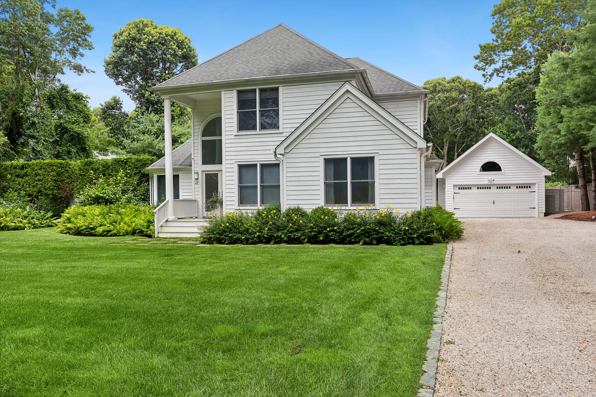 47 Tansey Lane Bridgehampton, NY 11932 - Photo 28 of 28 a view of a white house with a yard and potted plants
