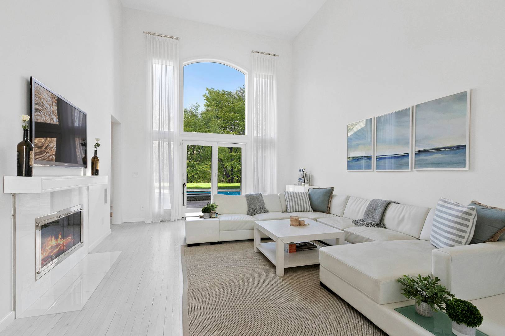 47 Tansey Lane Bridgehampton, NY 11932 - Photo 5 of 28 a living room with furniture a flat screen tv and a fireplace
