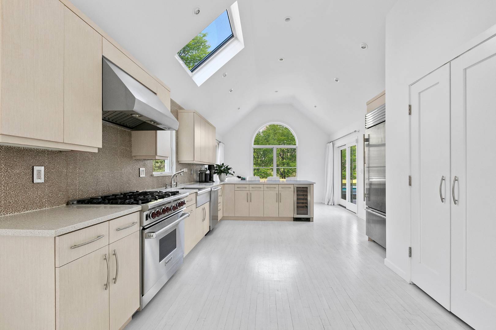 47 Tansey Lane Bridgehampton, NY 11932 - Photo 7 of 28 a large white kitchen with stainless steel appliances granite countertop a lot of counter space and a wooden floors
