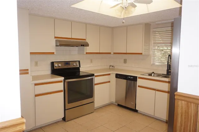 a kitchen with cabinets appliances and a sink