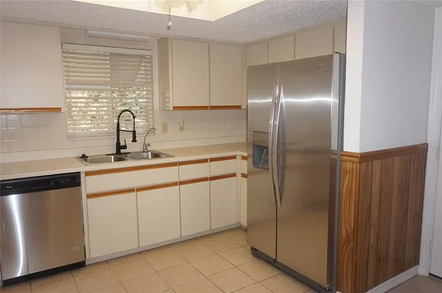 a kitchen with a refrigerator and a sink