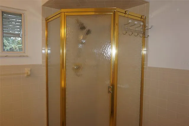 a bathroom that has a glass shower door