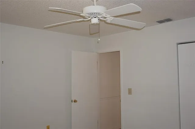 a view of a chandelier fan and a closet
