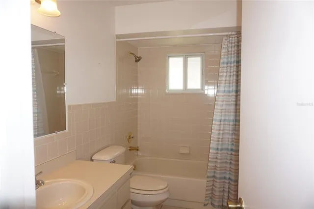 a bathroom with a toilet a sink and bathtub