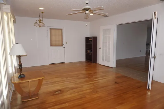 a view of empty room with wooden floor