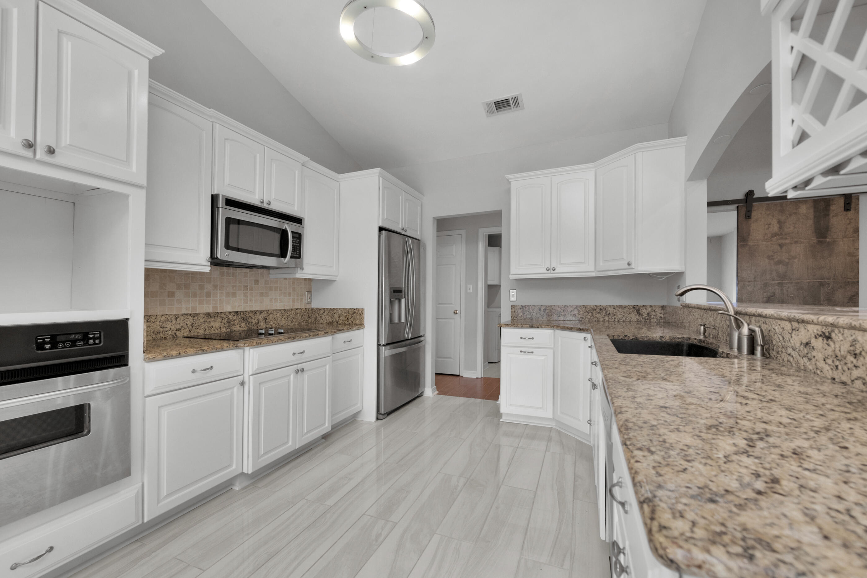 44 Beacon Way Santa Rosa Beach, FL 32459 - Photo 11 of 29 a kitchen with granite countertop a sink stove and refrigerator