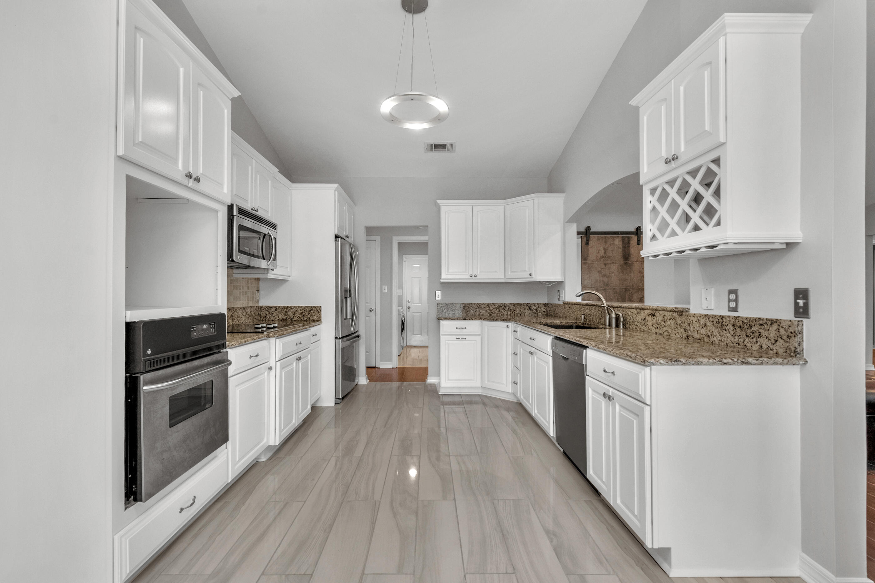 44 Beacon Way Santa Rosa Beach, FL 32459 - Photo 12 of 29 a large kitchen with cabinets wooden floor and stainless steel appliances