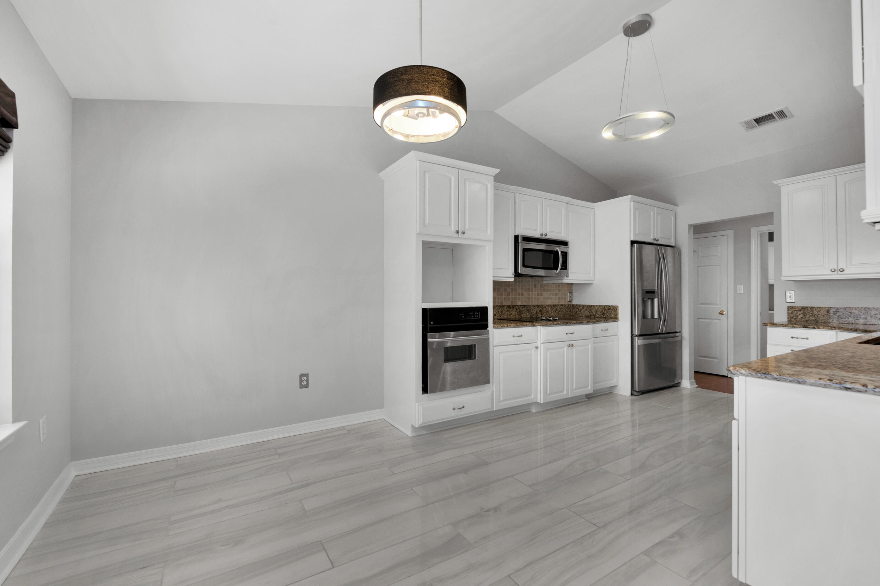 44 Beacon Way Santa Rosa Beach, FL 32459 - Photo 13 of 29 a kitchen with stainless steel appliances granite countertop a stove a sink dishwasher and a refrigerator with wooden floor