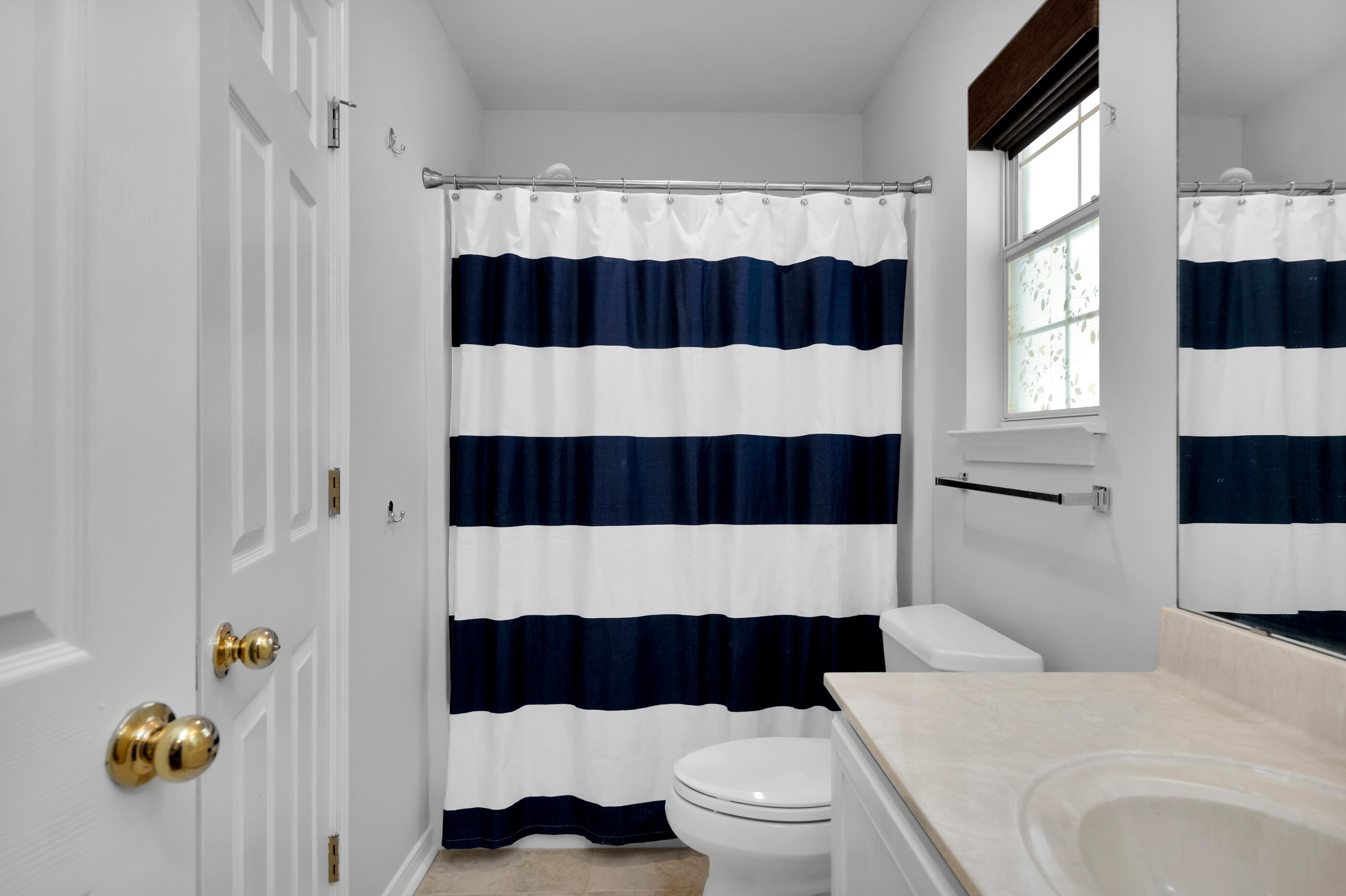 44 Beacon Way Santa Rosa Beach, FL 32459 - Photo 19 of 29 a bathroom with a sink a toilet and shower curtain