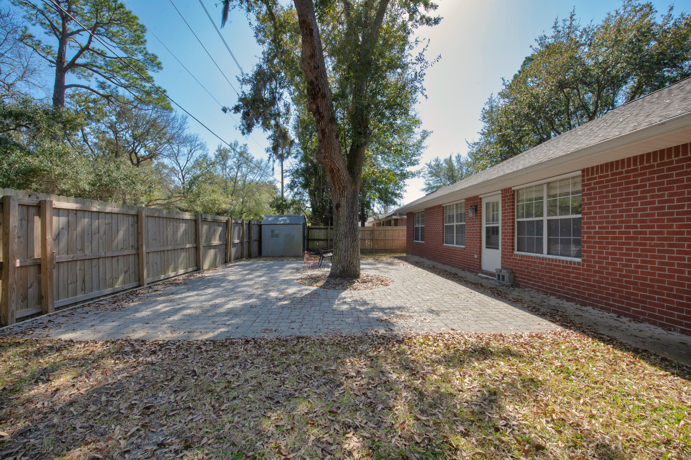 44 Beacon Way Santa Rosa Beach, FL 32459 - Photo 3 of 29 a view of a backyard with large trees and wooden fence