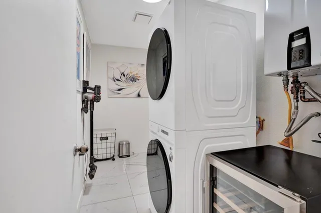 a view of living room filled with furniture and large windows