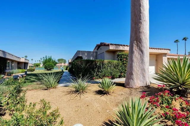 a bedroom with a bed a mirror and a painting on the wall