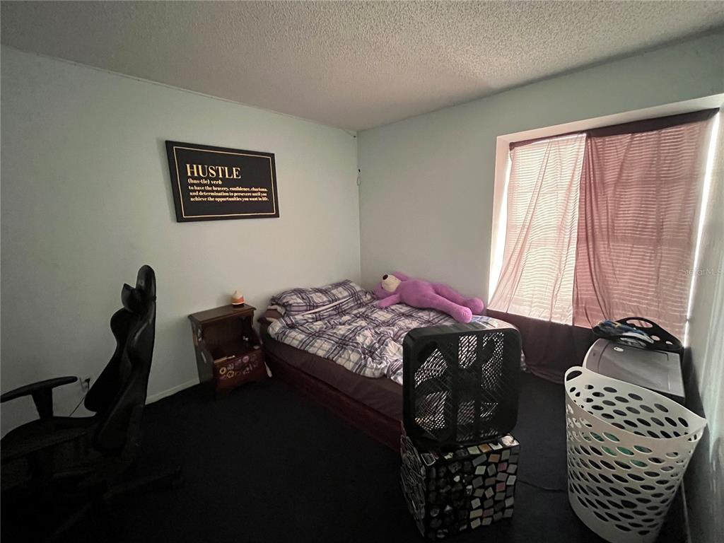 7502 Turtlebrook Lane New Port Richey, FL 34655 - Photo 12 of 21 a bedroom with a bed and wooden floor