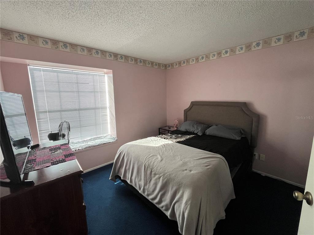7502 Turtlebrook Lane New Port Richey, FL 34655 - Photo 13 of 21 a bedroom with a bed and a window
