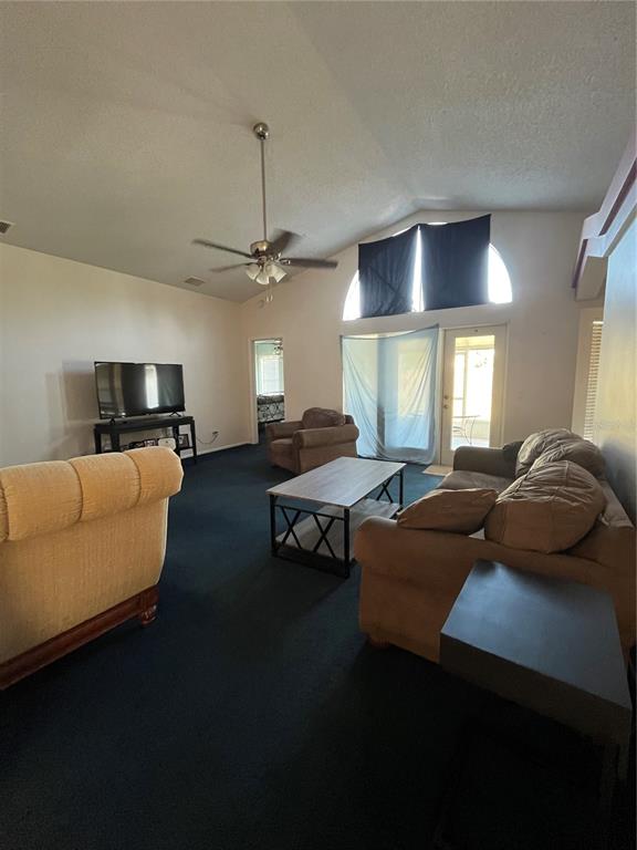 7502 Turtlebrook Lane New Port Richey, FL 34655 - Photo 7 of 21 a living room with furniture and a chandelier