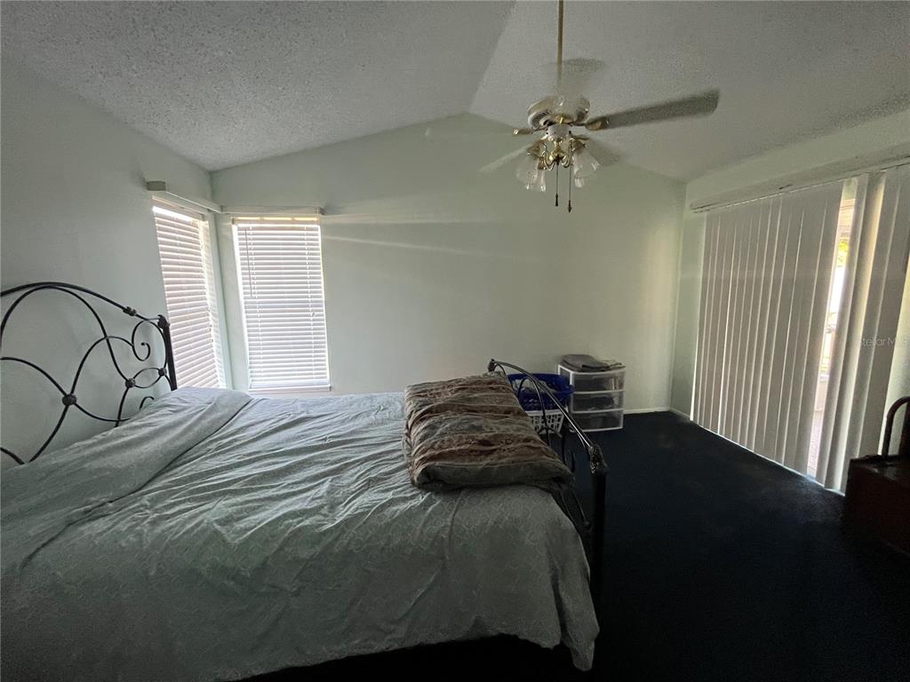 7502 Turtlebrook Lane New Port Richey, FL 34655 - Photo 8 of 21 a bedroom with a bed and a window