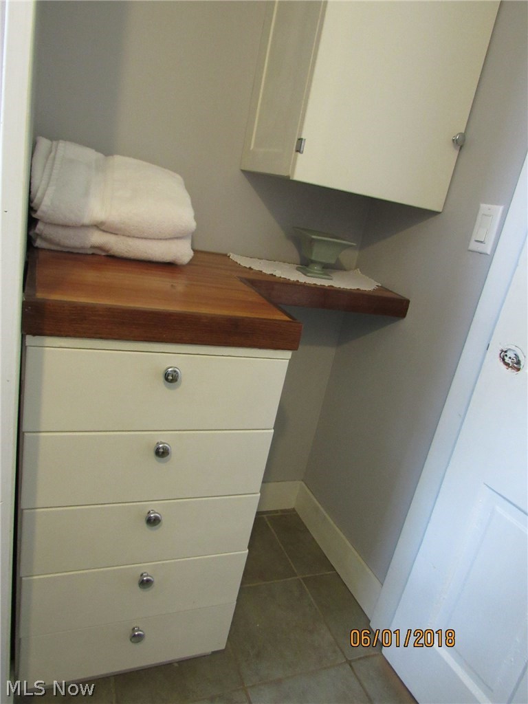 4444 Austin Road Geneva, OH 44041 - Photo 12 of 26 The bathroom off the kitchen has a nice custom built in for towels and toiletries.