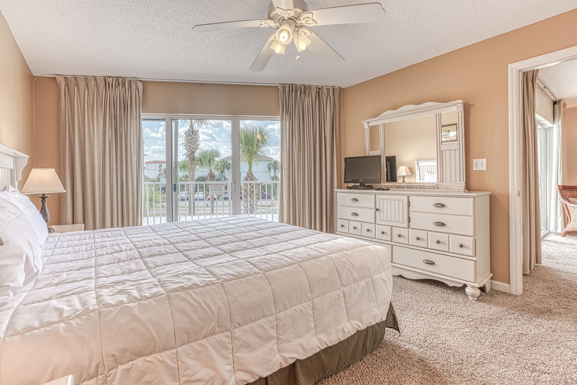 895 Santa Rosa Boulevard, Unit 214 Fort Walton Beach, FL 32548 - Photo 13 of 37 a bedroom with a large bed and a flat tv screen on dresser
