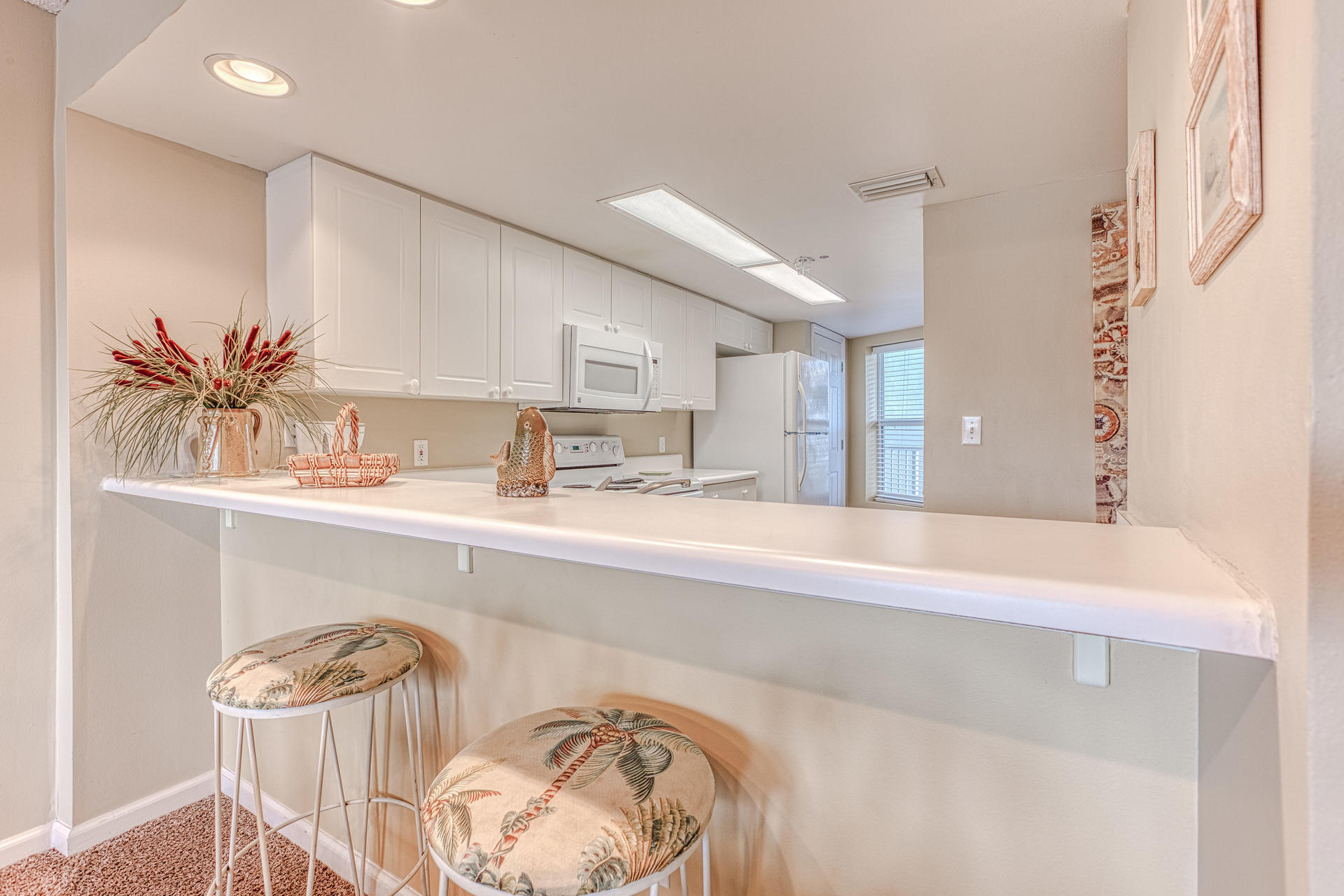 895 Santa Rosa Boulevard, Unit 214 Fort Walton Beach, FL 32548 - Photo 8 of 37 a kitchen with a sink a table and chairs