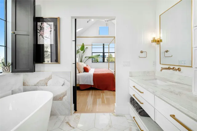 a white bath tub sitting next to a shower