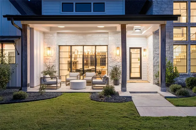 a living room with furniture and floor to ceiling windows