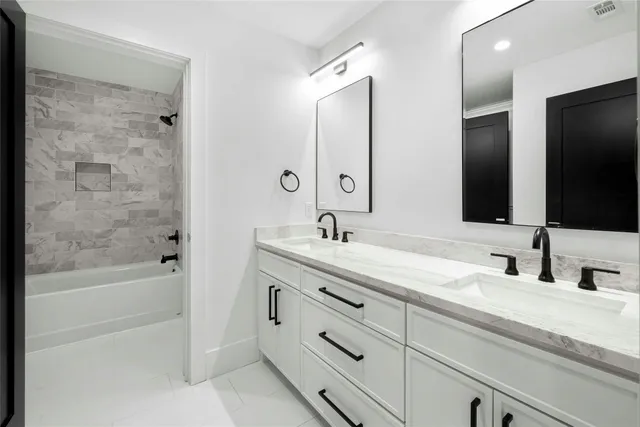 a bathroom with a granite countertop toilet sink and mirror