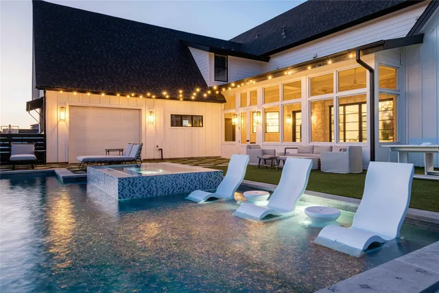 a view of swimming pool with seating area and hardwood floor