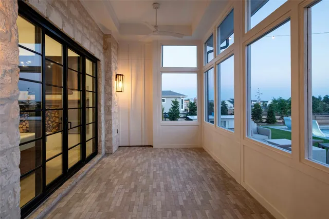 a outdoor space with patio couches a fireplace and a large window