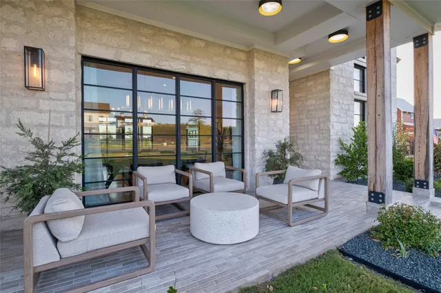 a building outdoor space with patio furniture and potted plants