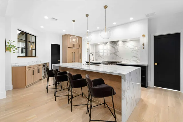 a large kitchen with a table and chairs