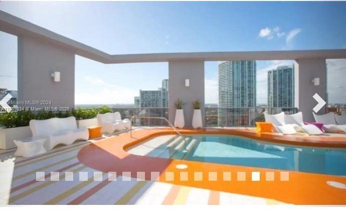 31 Southeast 6th Street, Unit 804 Miami, FL 33131 - Photo 13 of 13 a outdoor space with swimming pool and furniture