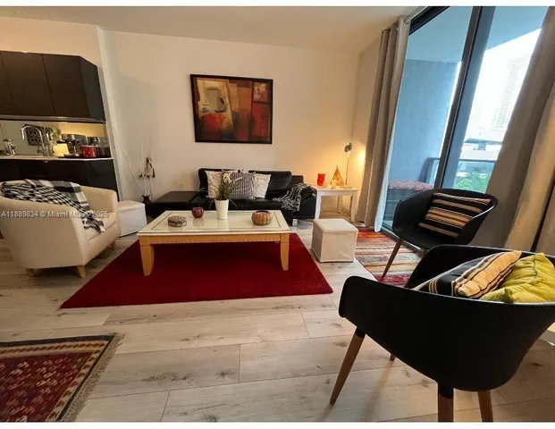 a living room with furniture and a window