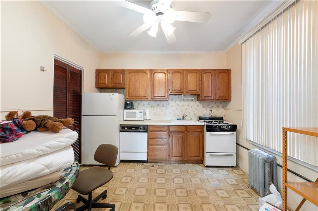 5003 Ave. M Brooklyn, NY 11234 - Photo 4 of 11 a kitchen with a refrigerator stove top oven and sink