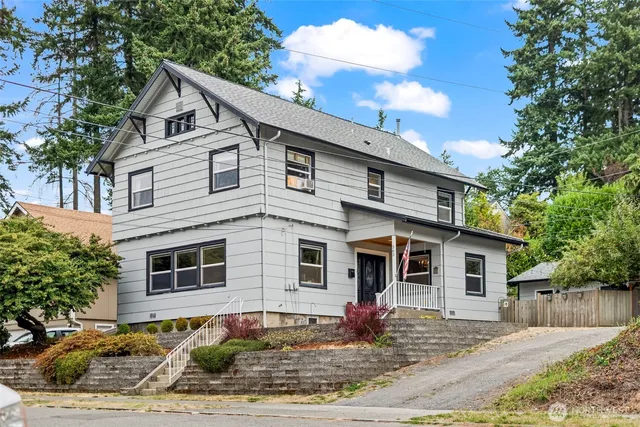 a front view of a house with a garden